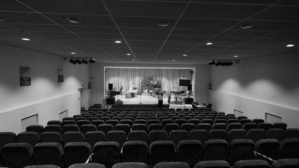 Empty conference auditorium with stage and rows of seats