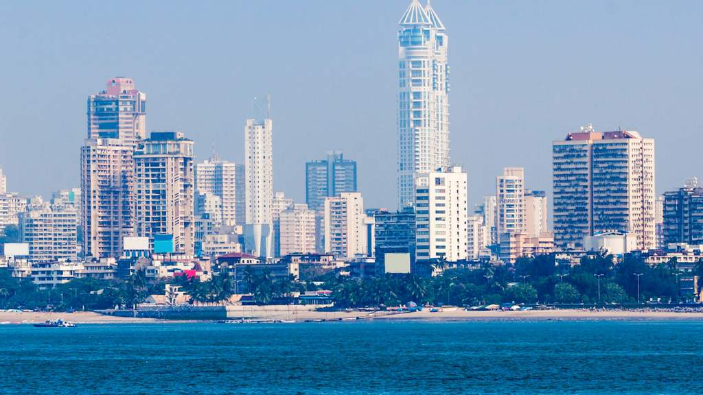 Mumbai skyline of high-rise towers seen across the sea from Marine Drive